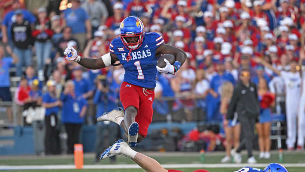 Oct 7, 2023; Lawrence, Kansas, USA; Kansas Jayhawks safety Kenny Logan Jr. (1) hurdles a teammate during a kick-off return against the UCF Knights during the second half at David Booth Kansas Memorial Stadium. Mandatory Credit: Peter Aiken-USA TODAY Sports  